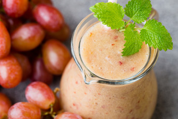 Grape smoothie, on the grey  background.