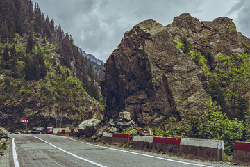 Spectacular view of the famous Transfagarasan road meandering through high rocky steep gorges at an...
