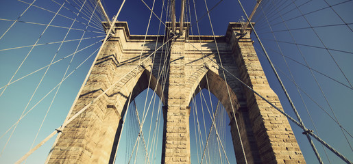 detail of Brooklyn Bridge with blue sky, New York City, USA, vintage filtered style
