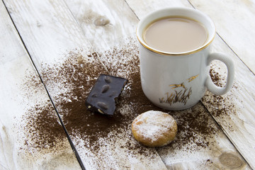 Cookie, cocoa and cup of coffee on wooden table