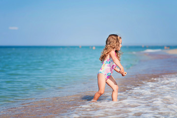 Fototapeta na wymiar happy girl having fun on a beach