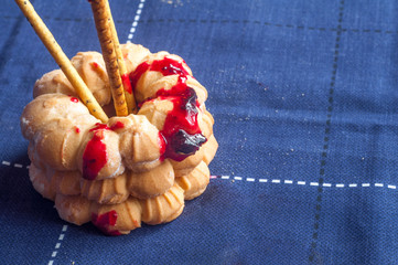 Baking, sweet biscuits and sprinkled with sweet sugar. Red jam.