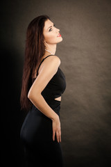 Fototapeta premium woman in sensual black dress on dark