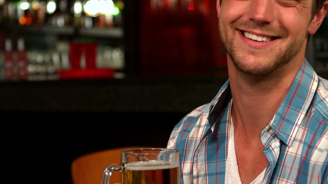 Handsome man having a pint