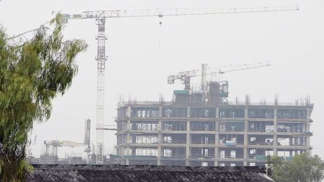 Zoom in shot of a crane at a construction site, Noida, Uttar Pradesh, India