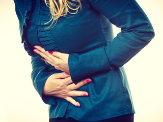 Elegant woman with stomach ache