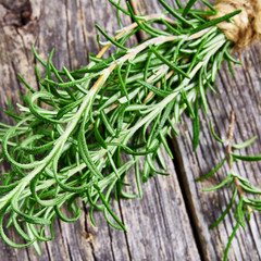 Bunch of fresh rosemary herbs on rustic wooden table