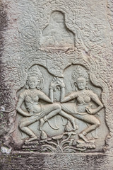 Fototapeta na wymiar Historic Khmer bas-relief showing dancing Hindu godesses at Bayon temple, Cambodia