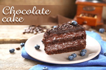 Chocolate cake with chocolate cream and fresh blueberries on plate, on wooden background