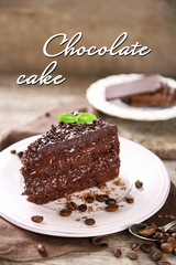 Chocolate cake with chocolate cream and fresh berries on plate, on wooden background