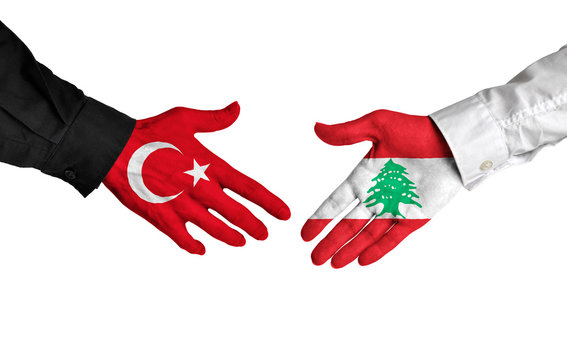 Turkey and Lebanon leaders shaking hands on a deal agreement