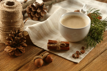 Cup of coffee on napkin on wooden background