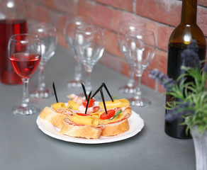 Delicious canape and wine on the kitchen table, close up