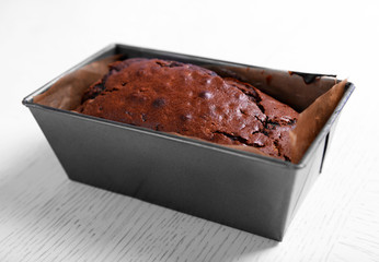 Chocolate cake in baking dish on white table
