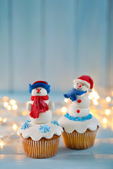 Christmas cupcakes with lights on background