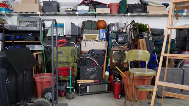 Vintage junk filled garage dolly shot.  Object brand names and logos were covered.