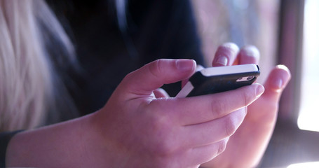 woman typing on her phone, woman into technology