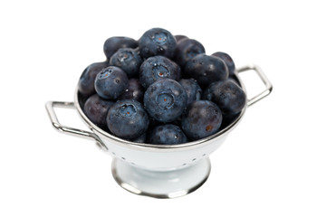 Blueberries in a Colander Isolated on white background. Selective focus.