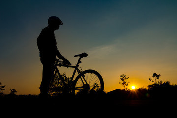 A silhouette of biker at sunset