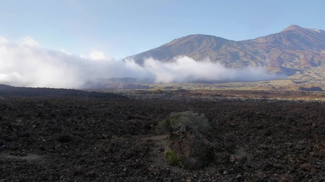 Clouds rolling across plains near the Teide volcano on Tenerife island, Canary Islands, Spain.