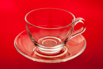 Empty glass cup and saucer