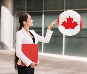 Woman point on the bubble with canadian flag