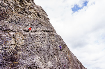 Climbers practicing their rock climbing skills on the Steep Rock Walls of the mountains at the Grassi Lakes near Canmore in the Canadian Rockies