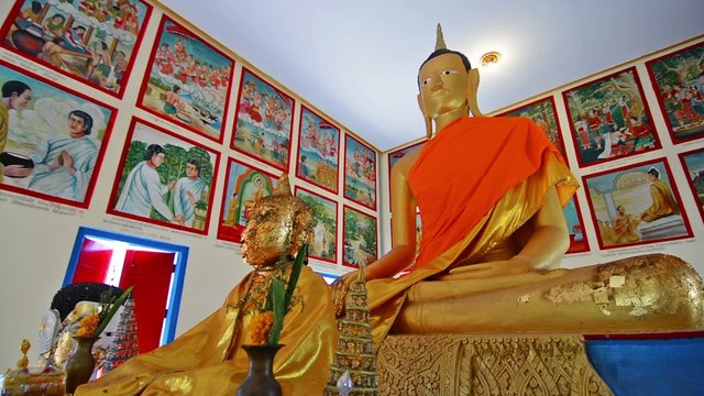 Dolly camera movement among Buddha sculptures