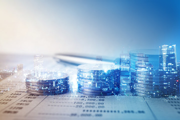 Double exposure of city and rows of coins for finance and banking concept
