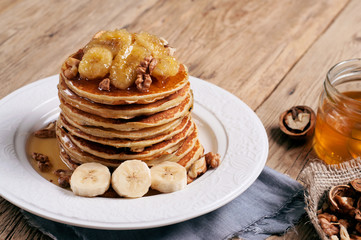 healthy breakfast of pancakes with honey, nuts and caramelized b