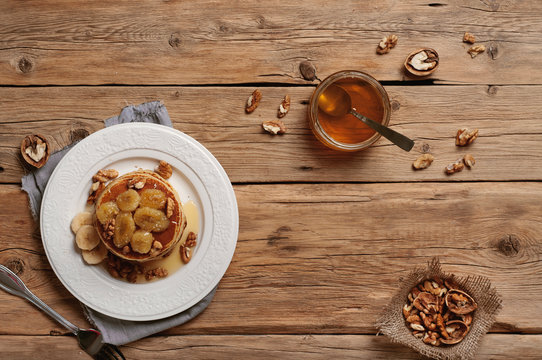 healthy breakfast of pancakes with honey, nuts and caramelized b