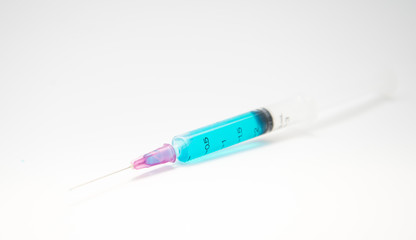 Syringe, medical injection in hand.