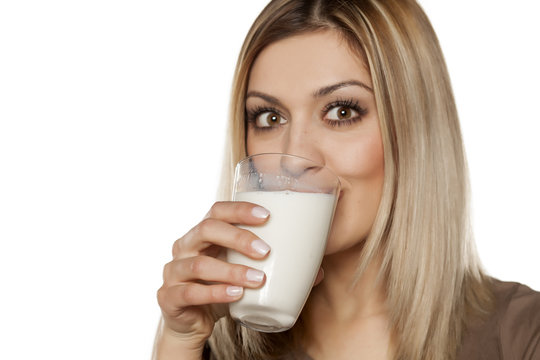 happy young woman drinking milk from a glass
