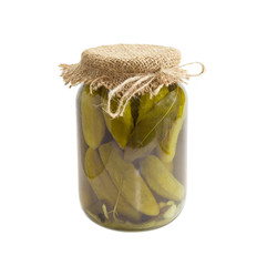 Canned cucumbers in glass jar on a light background