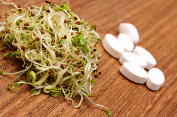 Alfalfa and radish sprouts with tablets supplements, healthy nutrition