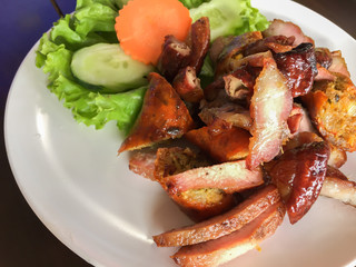 grilled pork on clean dish with vegetables