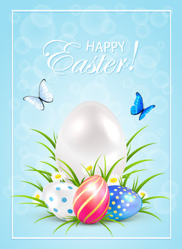 Easter eggs on grass and butterflies on blue background