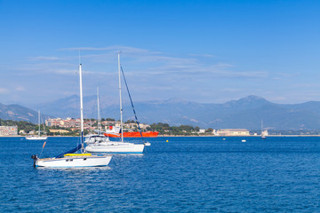 Fototapeta na wymiar Sailing yachts and motorboats moored in bay of Ajaccio