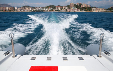 Obraz na płótnie Canvas Bow wave of fast motor boat departures port of Ajaccio