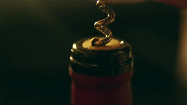 Opening the Wine Bottle with a Corkscrew