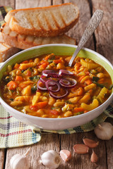 Traditional Tuscan ribollita vegetable soup close up in a bowl. vertical
