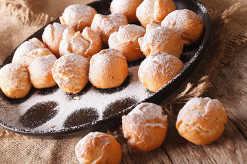 Italian sweet donuts Castagnole close-up on the table. Horizontal
