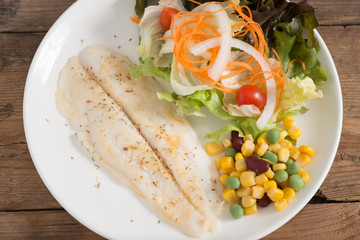 Clean food, Fish fillet steak with salad vegetables. Top view.