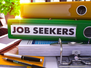 Green Office Folder with Inscription Job Seekers on Office Desktop with Office Supplies and Modern Laptop. Job Seekers Business Concept on Blurred Background. Job Seekers - Toned Image. 3D.