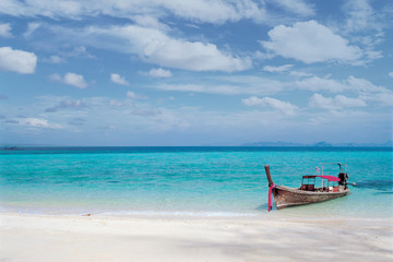 A boat on the clear beach. 