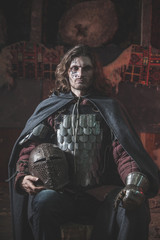 Fototapeta na wymiar Long haired medieval knight in the armor