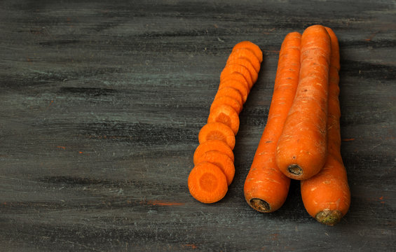 Carrots on the gray blue painted wooden background