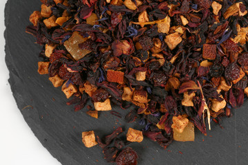Still life, aromatic dry tea with fruits and petals