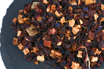 Still life, aromatic dry tea with fruits and petals