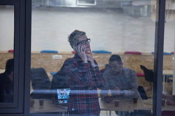 business woman in meeting room  speaking by cell phone